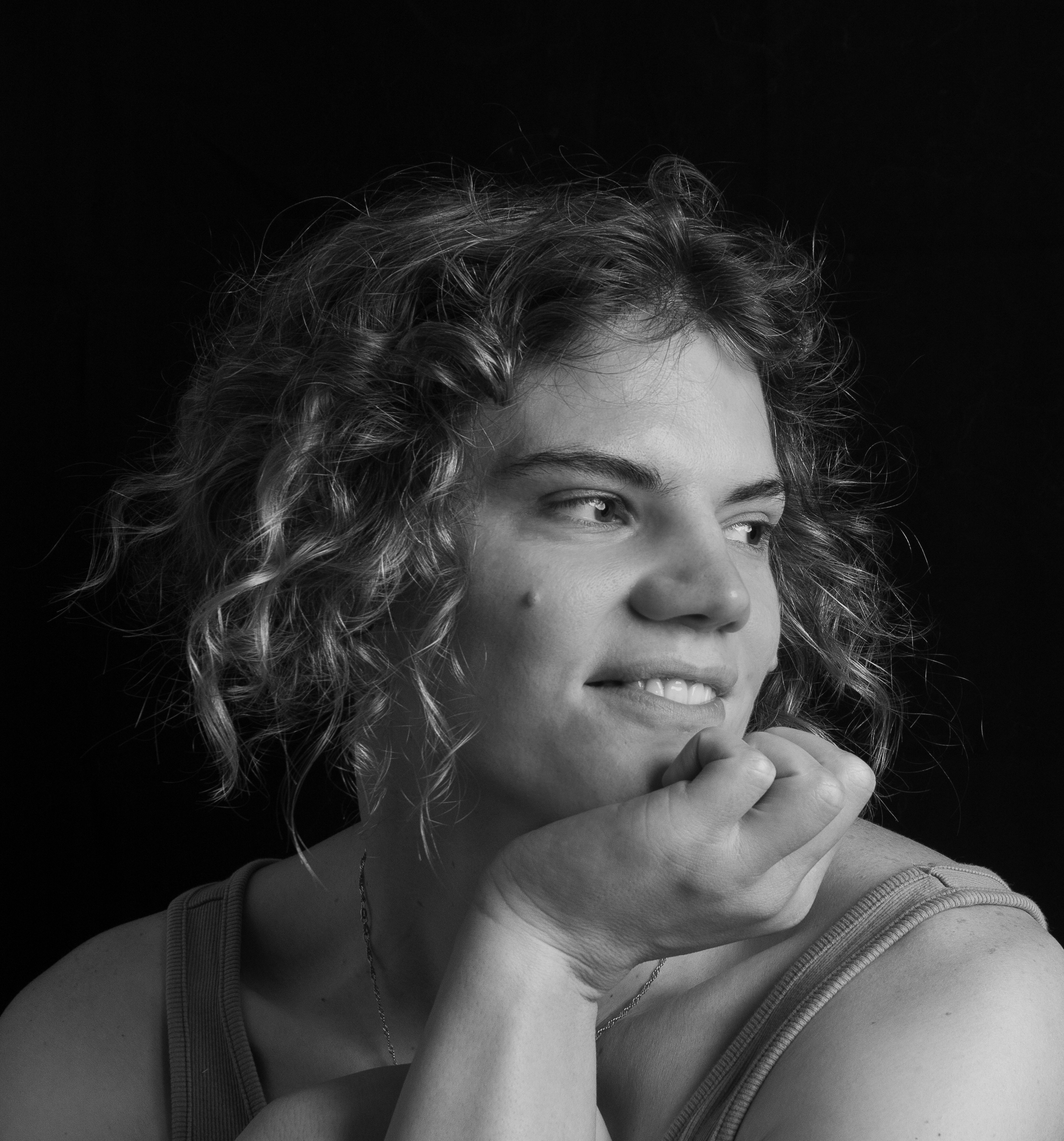 Held in the Blur portrait with a hand shielding the face